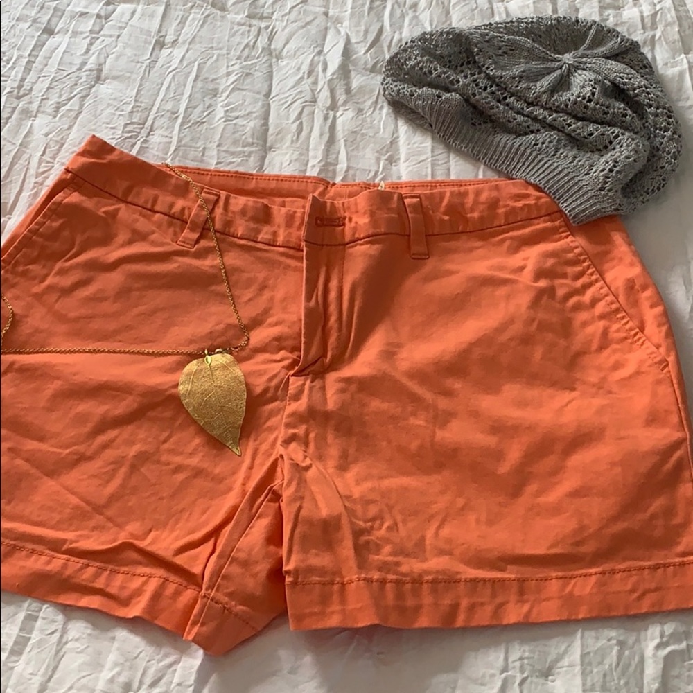 One pair of orange shorts, size 12.